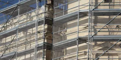 Picture of a large building clad in scaffolding and netting