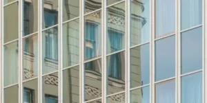 exterior photo of large office windows reflecting the building opposite